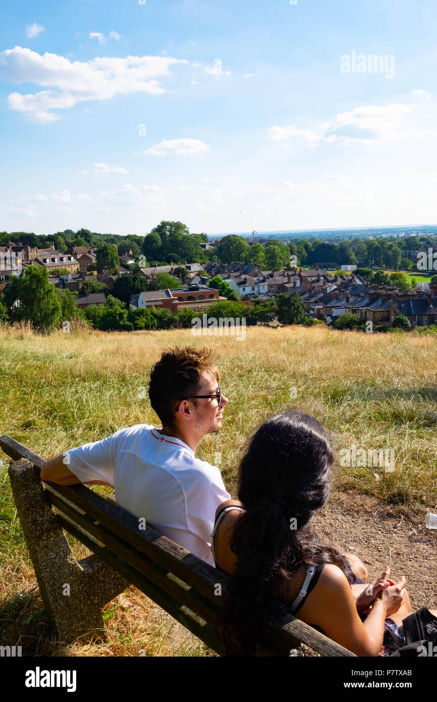 London, England. 7th July 2018. Ekta and Dan enjoying the view over Harrow in the sunshine. The present heatwave is set to continue. ©Tim Ring/Alamy Live News Stock Photo