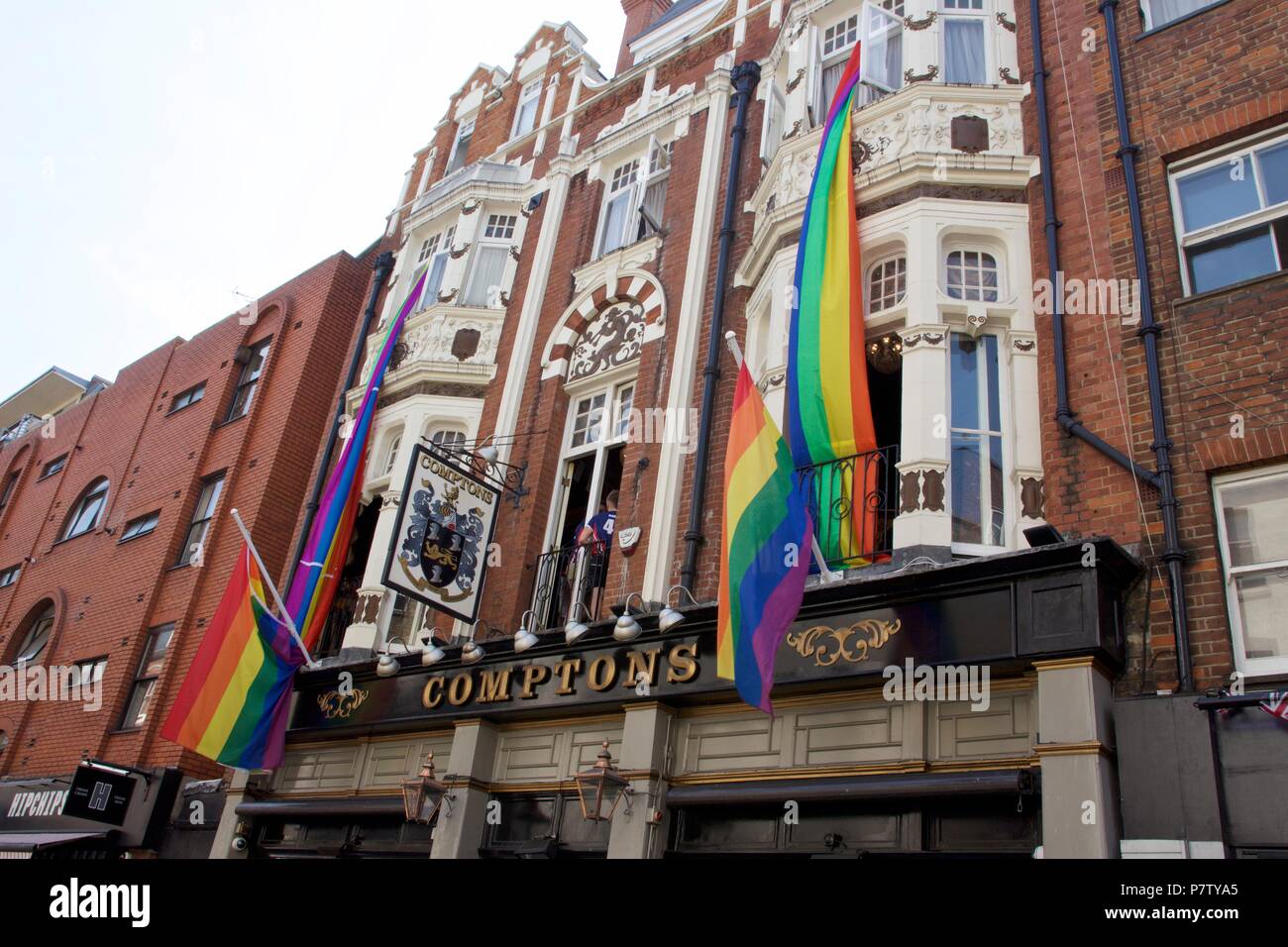 London, UK. 7th July 2018. Pride celebrations in London. A pub called Comptons on Old Compton Street, Soho displaying many rainbow flags to celebrate Pride of London 2018. Credit: Dimple Patel/Alamy Live News Stock Photo