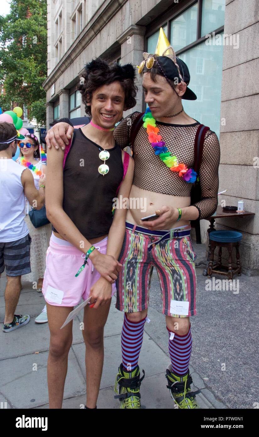 London, UK. 7th July 2018. Pride celebrations in London. Two men at Pride in London Parade 2018 together, joining more than 1 million attending the march today to celebrate LGBT+. Credit: Dimple Patel/Alamy Live News Stock Photo