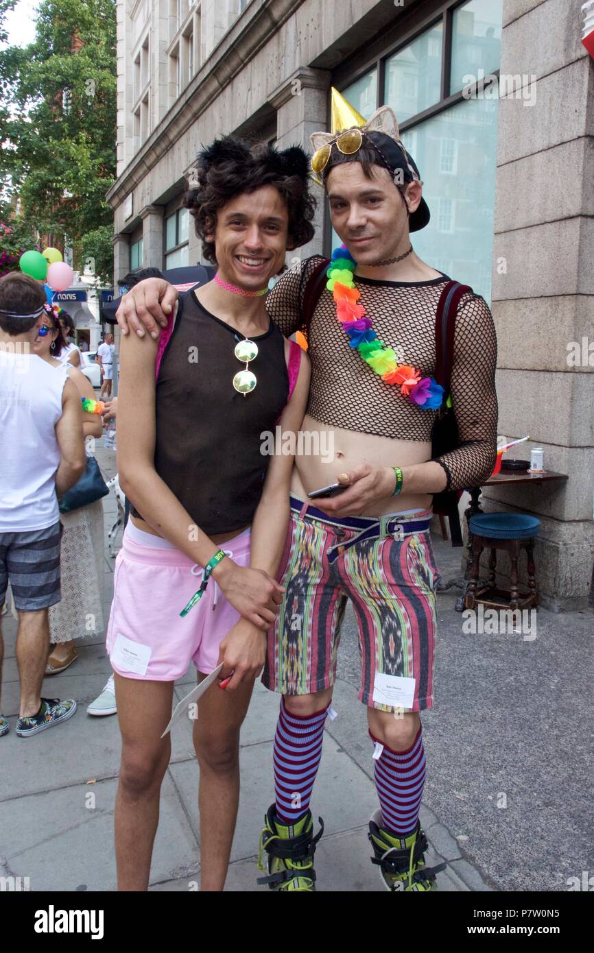 London, UK. 7th July 2018. Pride celebrations in London. Two men at Pride in London Parade 2018 together, joining more than 1 million attending the march today to celebrate LGBT+. Credit: Dimple Patel/Alamy Live News Stock Photo