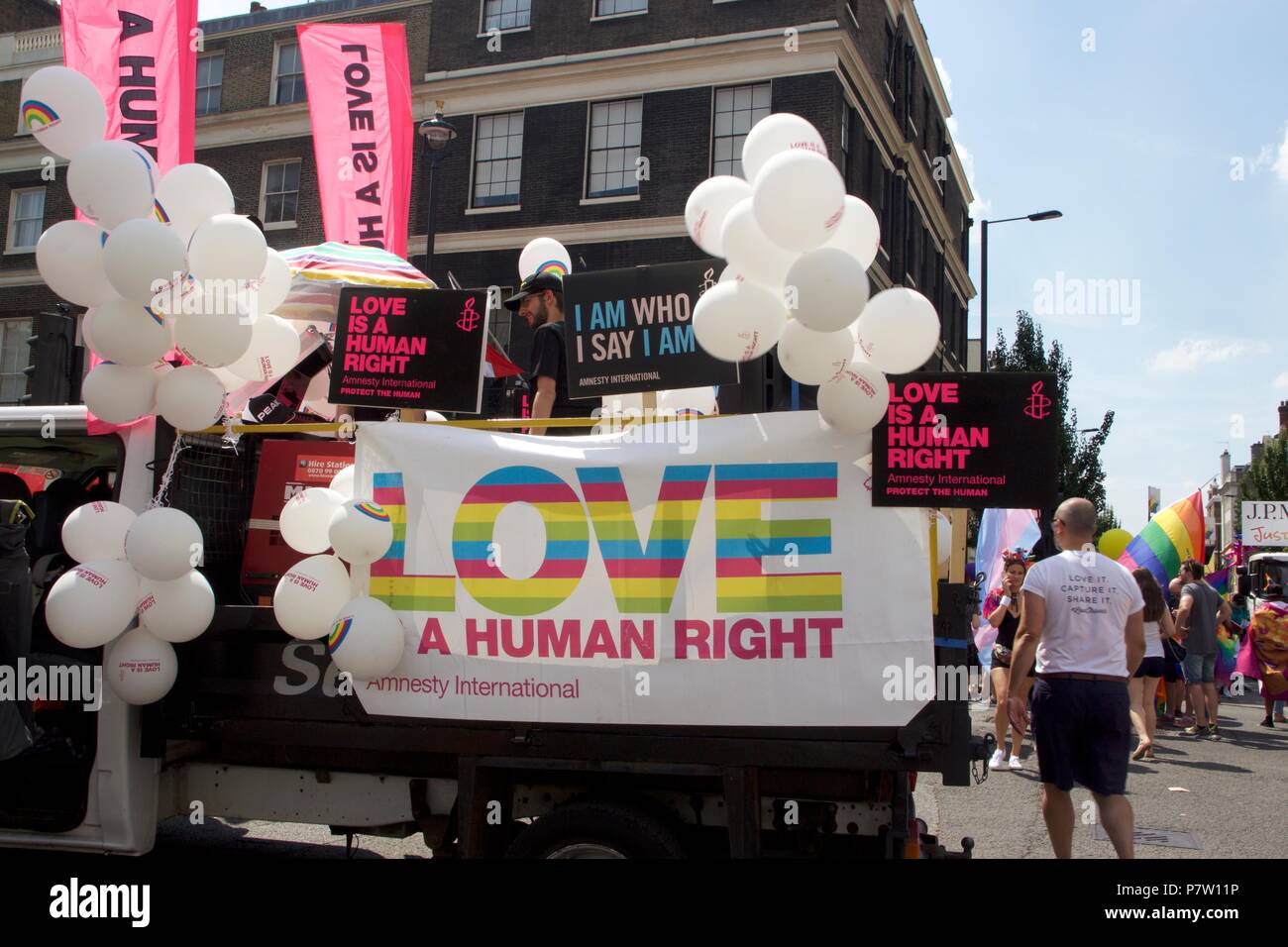London, UK. 7th July 2018. Amnesty International float which says 'Love is a human right' in Pride in London 2018 Parade, joining more than 1 million attending the march today to celebrate LGBT+. Credit: Dimple Patel/Alamy Live News Stock Photo