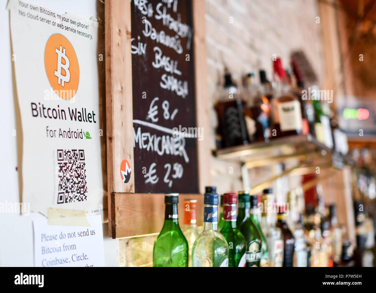 Germany, Berlin. 19th July, 2018. The logo of Bitcoin can be seen in the  window of the bitcoin bar 
