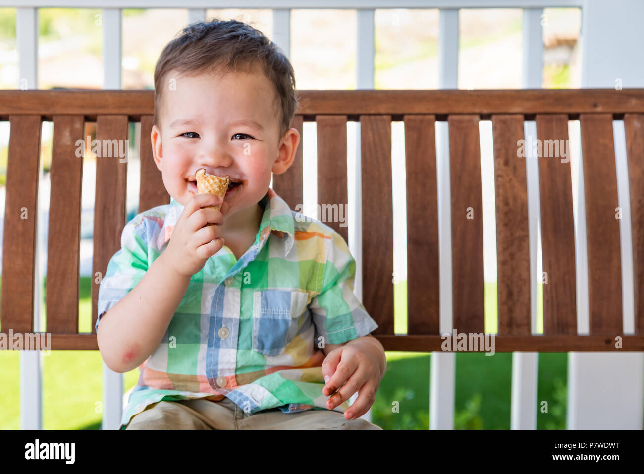 Young Mixed Race Chinese and Caucasian Boy Enjoying His Ice Cream Cone