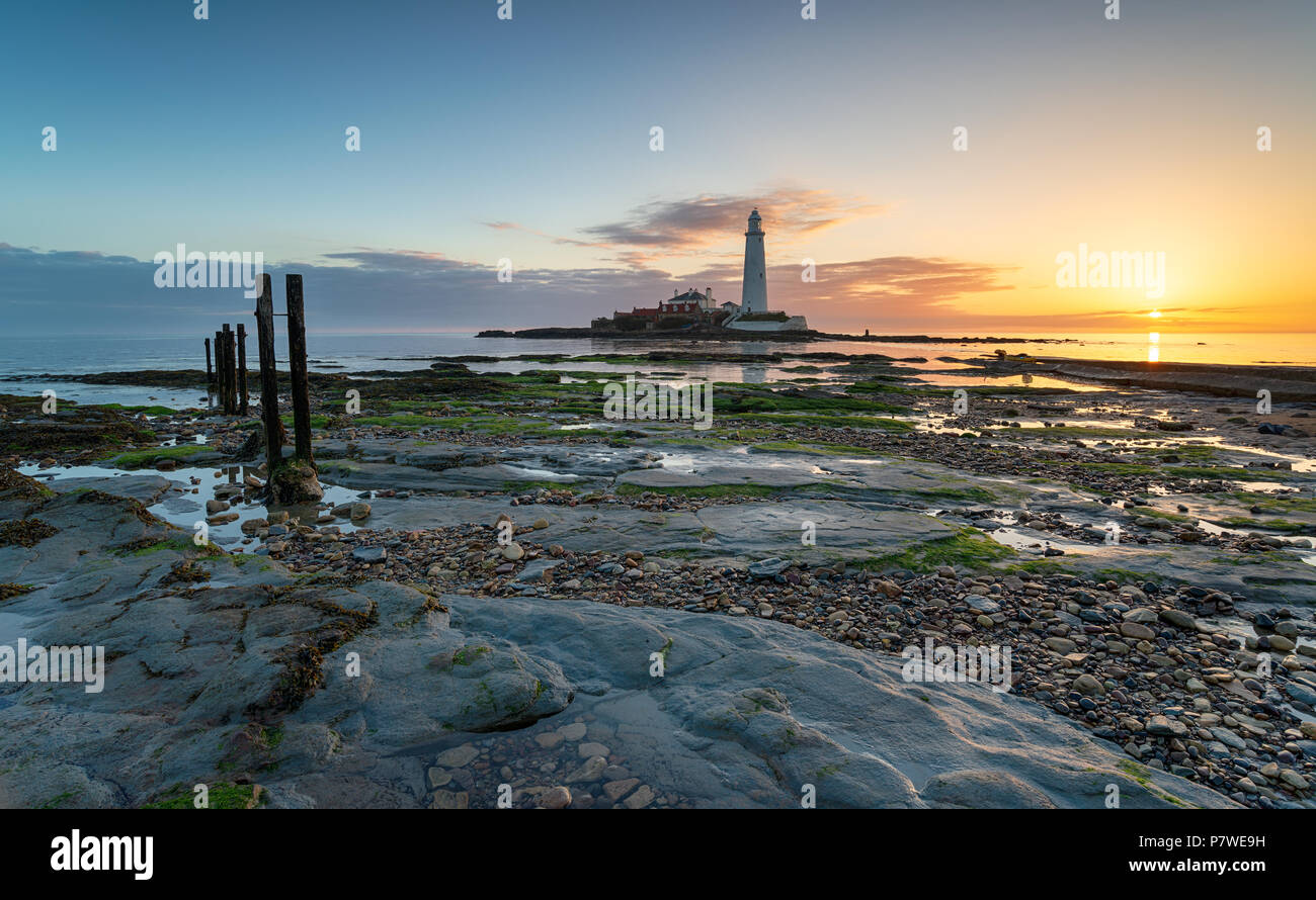 Beautiful sunrise over St Mary's Island and it's lighthouse at Whitley Bay in Tyne and Wear Stock Photo