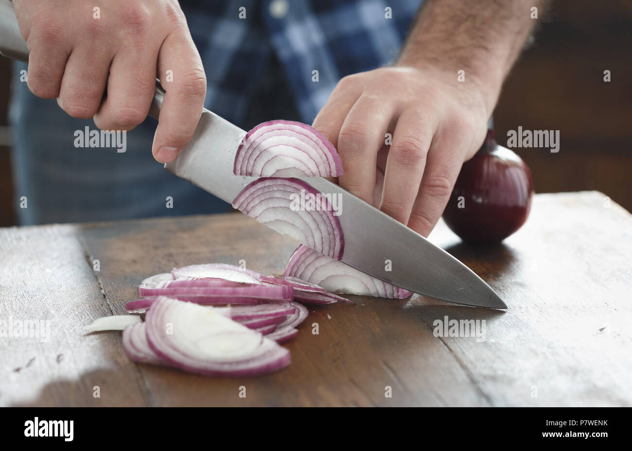 Close up male hands chopped fresh red onion on wooden table Stock Photo ...