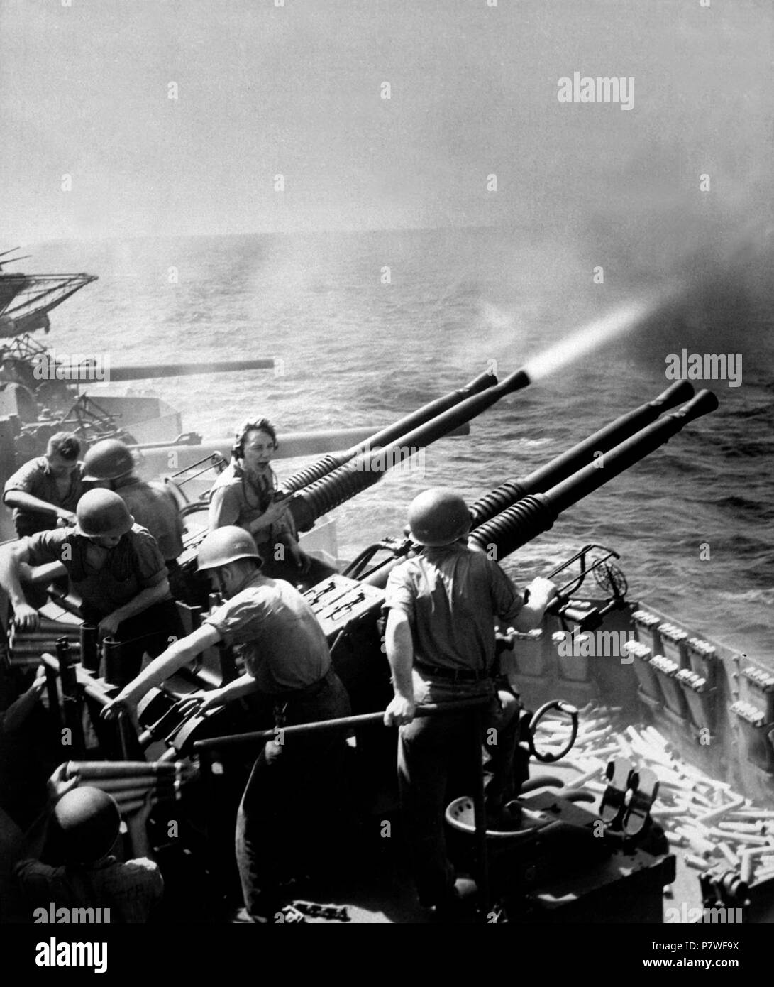 40mm guns firing aboard USS Hornet. Task Force 58 raid on Japan. 40mm ...