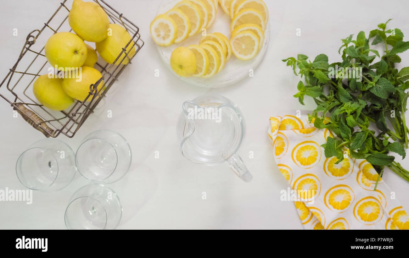 Step by step. Preparing traditional fresh lemonade in glass pitcher