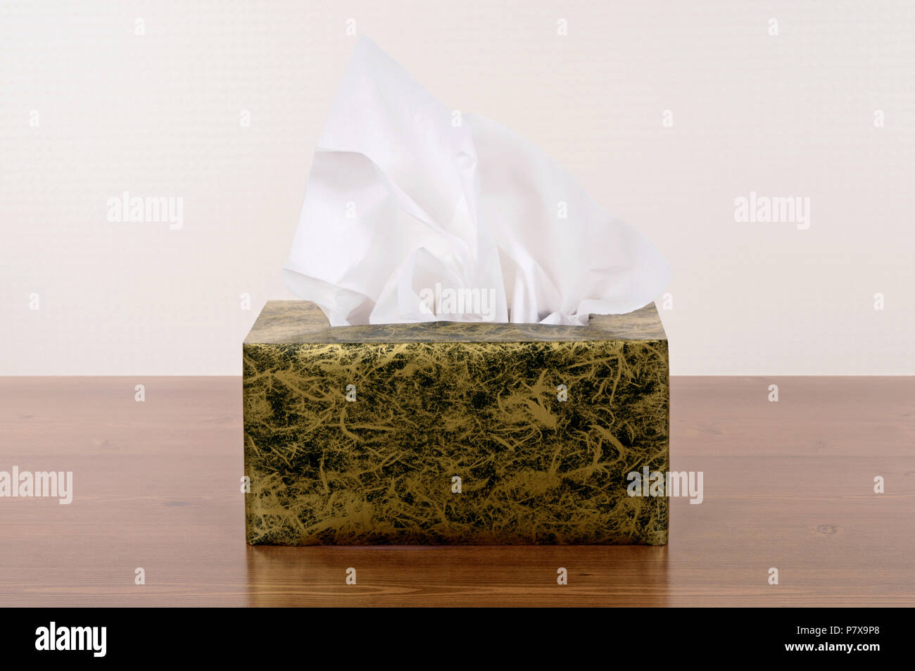 Box of tissues on a wood table. Stock Photo