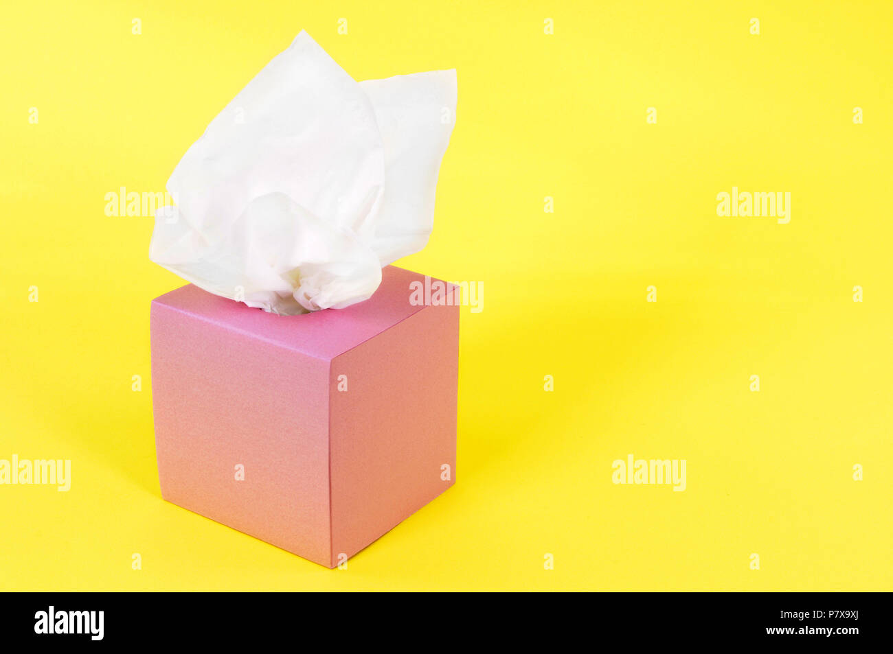 Tissues in blank pink box isolated on a yellow background. Stock Photo