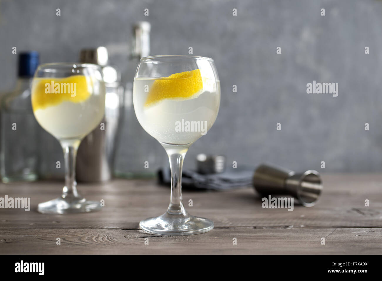 Vesper Martini Cocktail with lemon wedge. Homemade Vesper Cocktail on table, copy space. Stock Photo