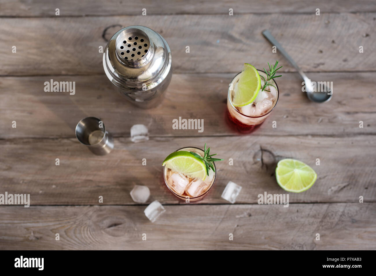 Sloe Gin Fizz Cocktail. Pink cold alcohol drink with ice, lime and soda