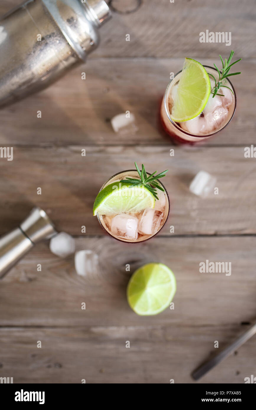 Sloe Gin Fizz Cocktail. Pink cold alcohol drink with ice, lime and soda