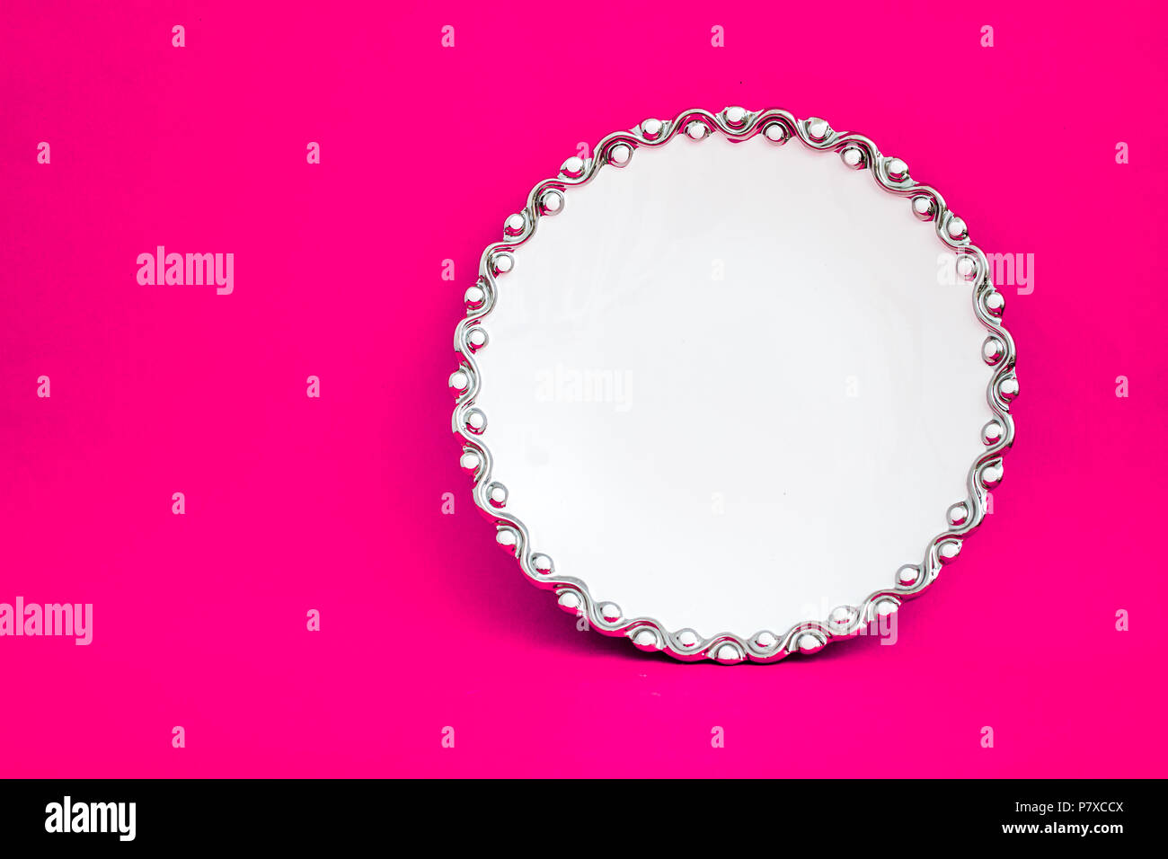 White porcelain plate on pink background Stock Photo - Alamy