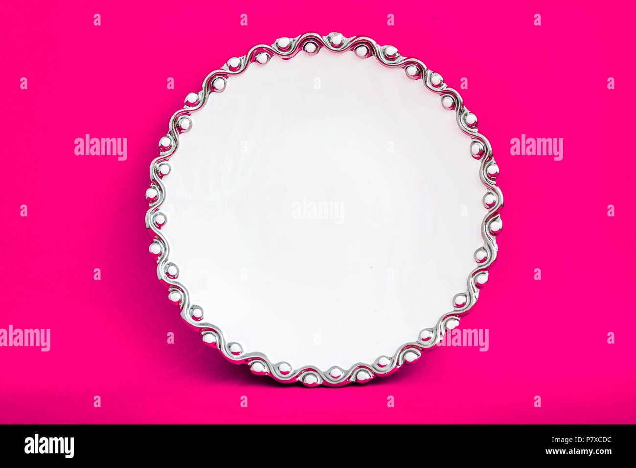 White porcelain plate on pink background Stock Photo - Alamy