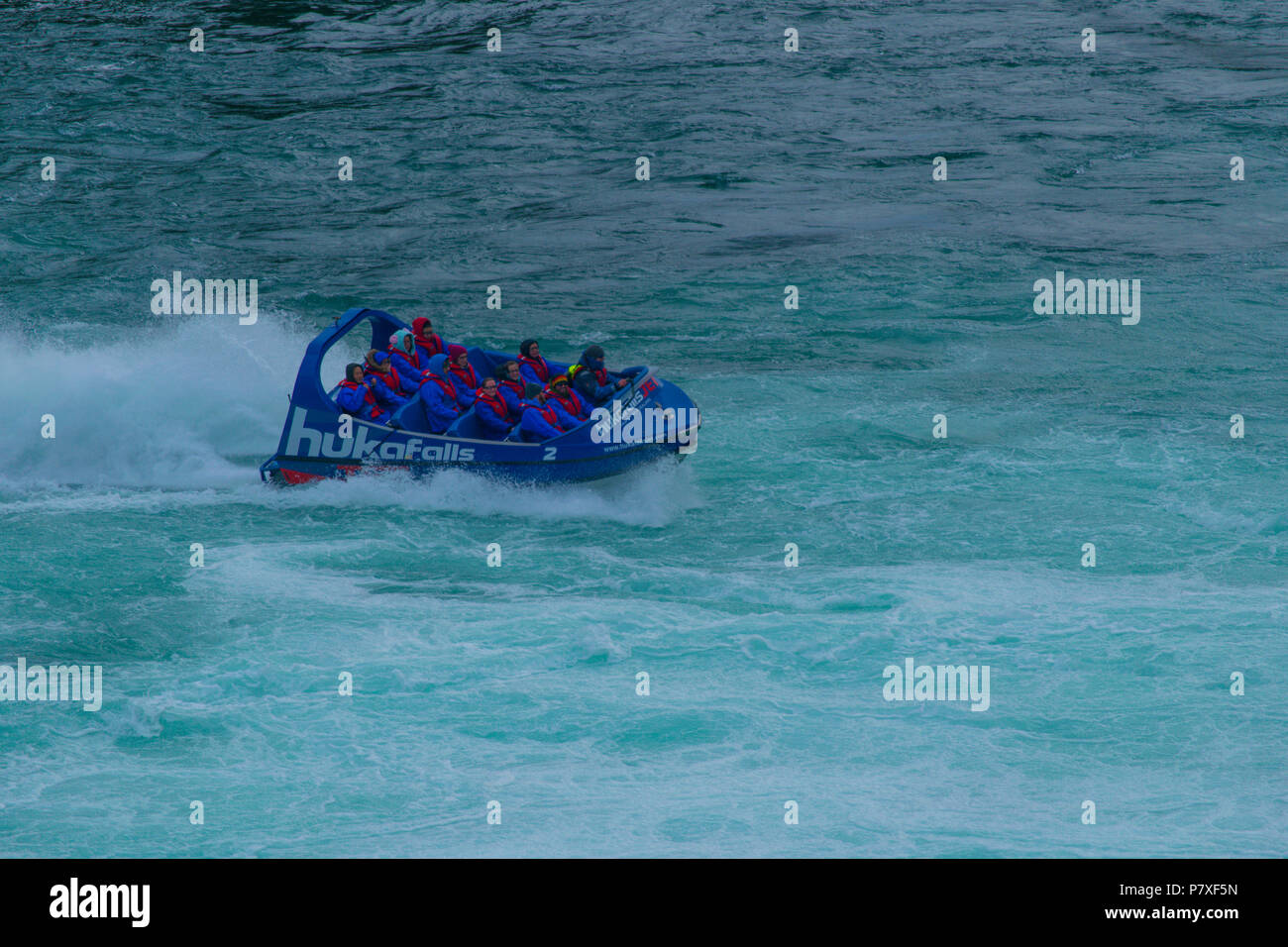 Huka Falls Jet Boat Cruising Through Rapids Stock Photo