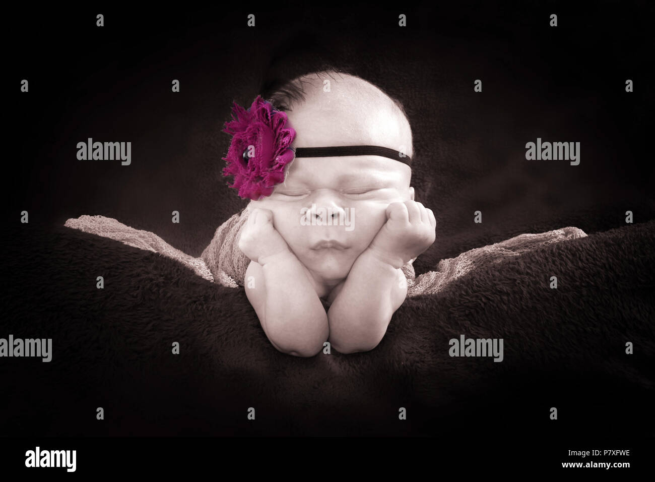 1 month old baby girl sleeping on tummy Stock Photo