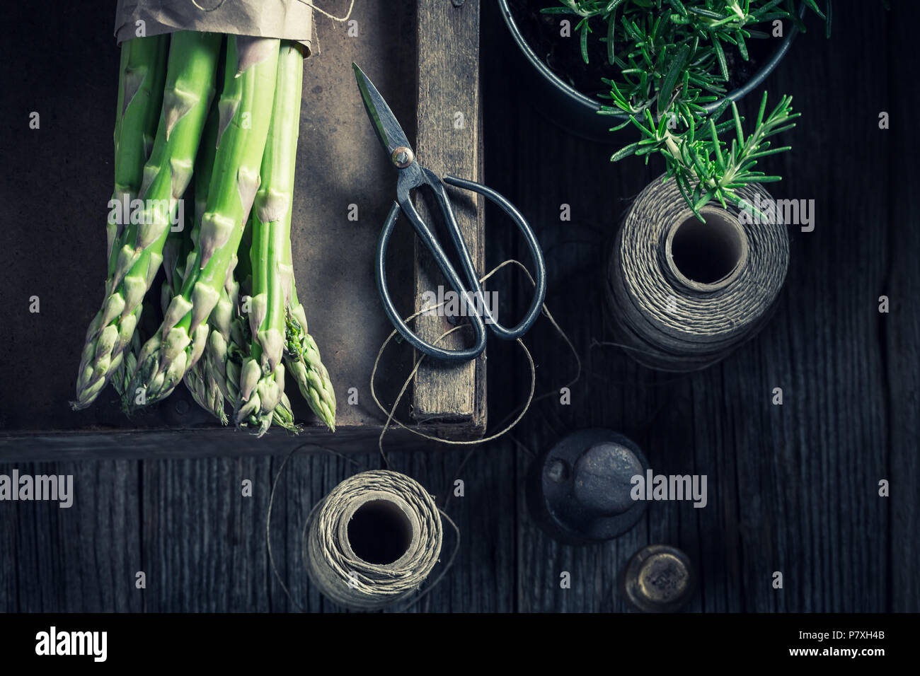 Rosemary, green asparagus and weights in rustic table Stock Photo Alamy