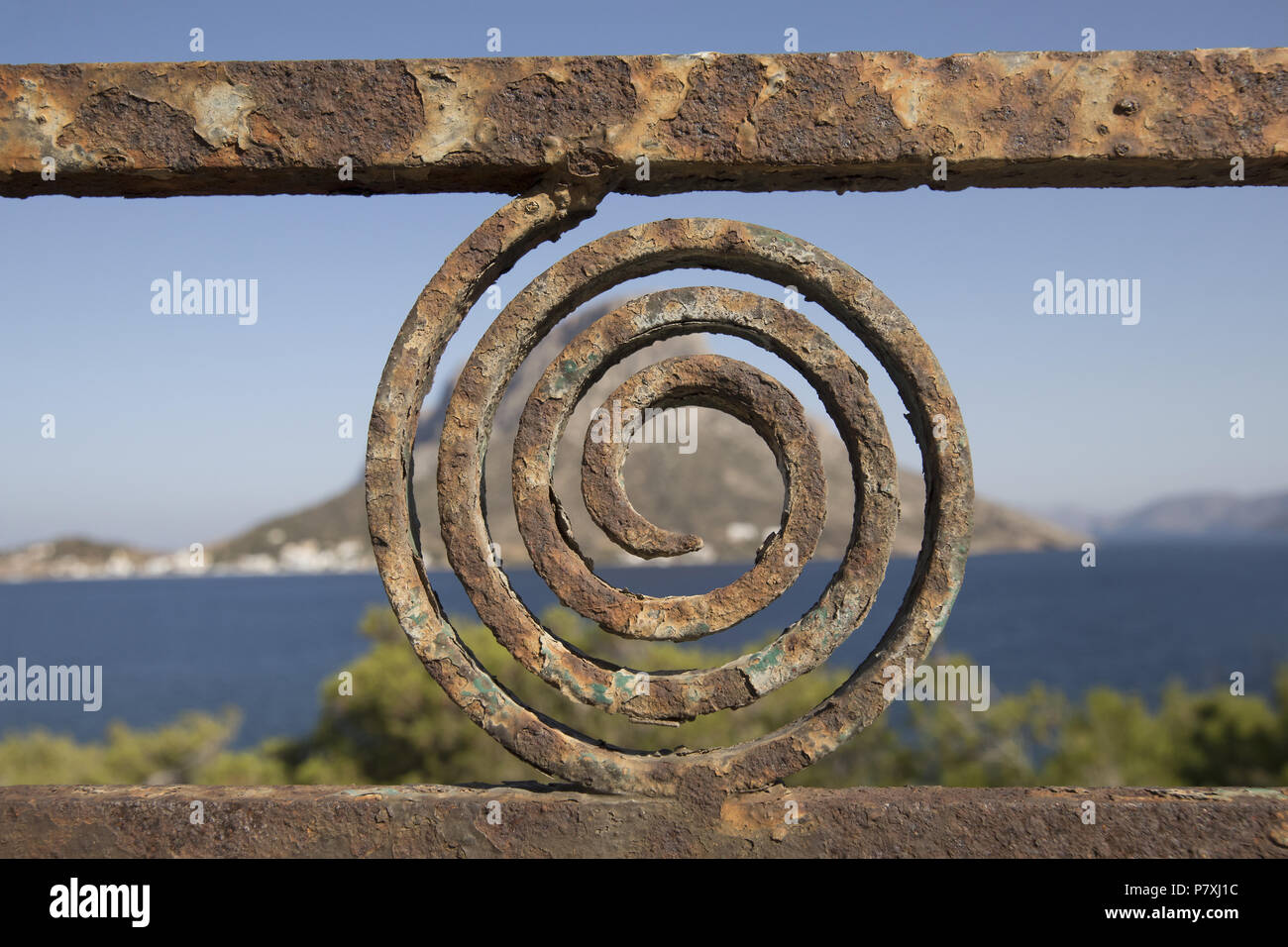 Gates and Railings in Masouri, Kalymnos, Greece. with a view over the sea to Telendos island Stock Photo