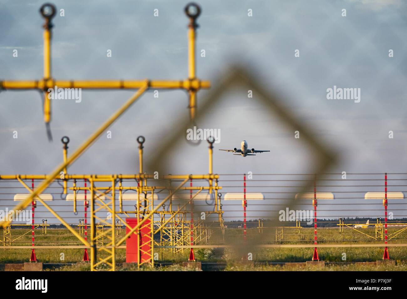 Traffic at the airport. Airplane during take off over landing lights