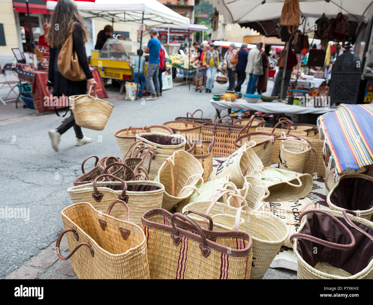 woman with basket passes a lot of baskets for sale on open air market in  french town of briancon Stock Photo - Alamy