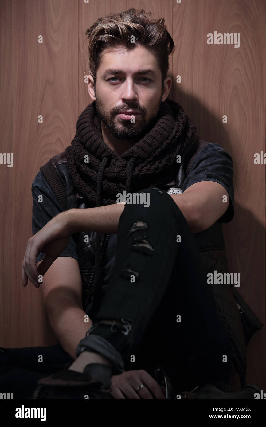 a man with a beard in casual clothes sits Stock Photo - Alamy
