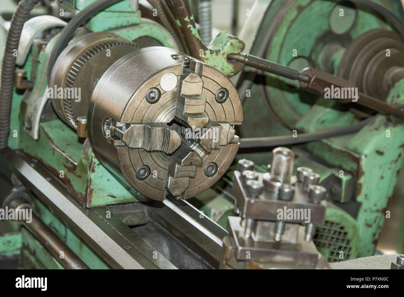 Old lathe is still at work in metalworking workshop Stock Photo