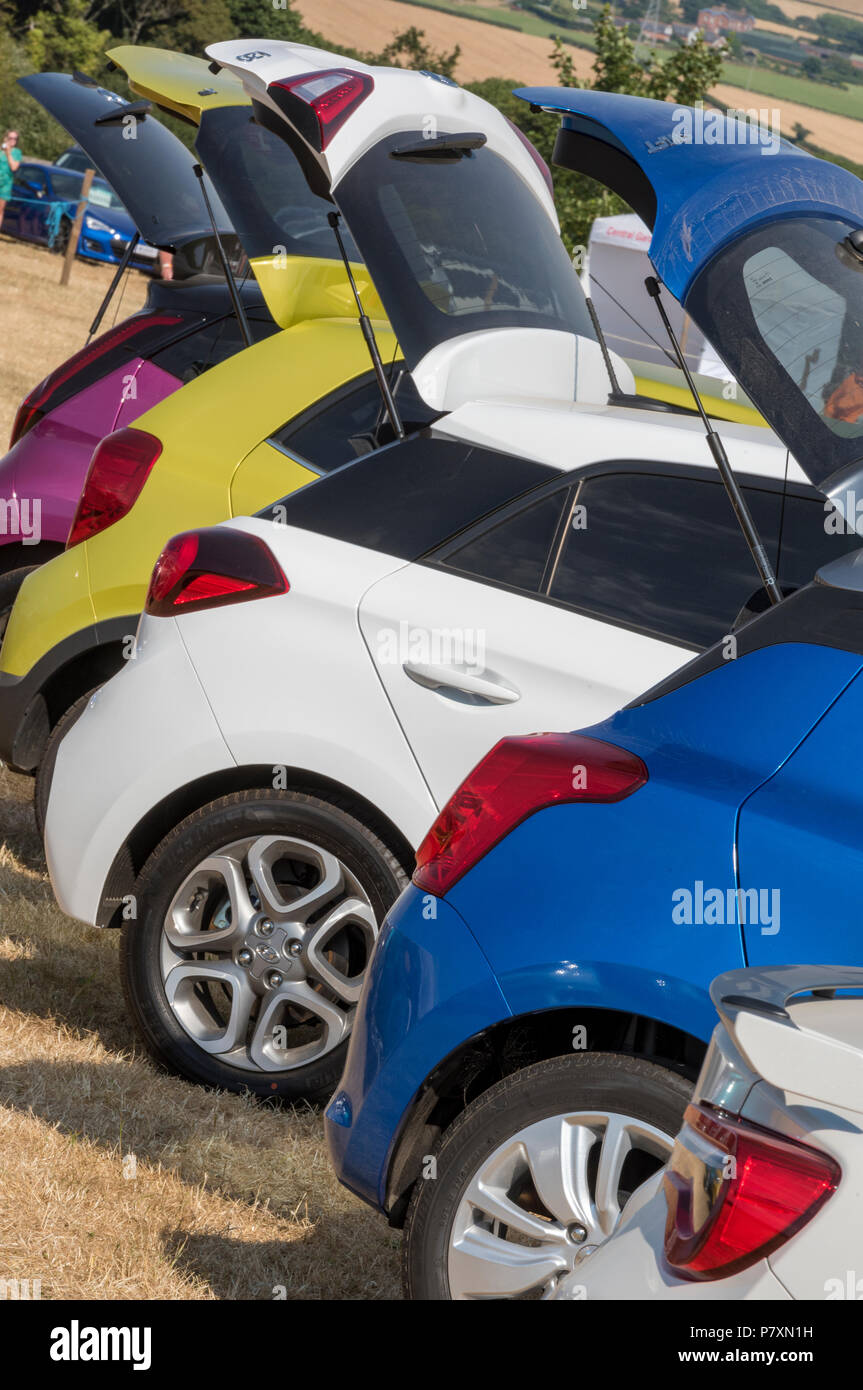 new cars for sale in different colours with the boot open. new car