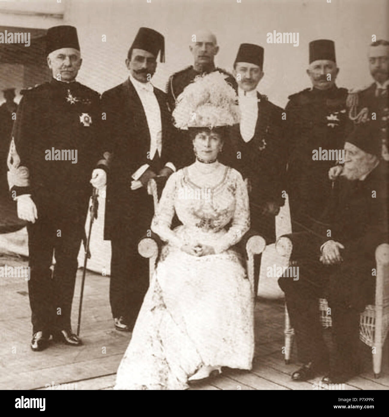 English: Photograph taken aboard HMS Medina at Port Said in December 1911. It was taken during a stopover of the ship bringing King George V and Queen Mary to India for the Delhi Durbar in the course of which George V will be formally proclaimed Emperor of India. Sitting next to Queen Mary is Kâmil Pasha, four-time grand vizier of Turkey. A well-known anglophile and an advocate of a British-style constitutional monarchy for the Ottoman Empire, the 78-year-old Kâmil Pasha, who spoke English, represented Sultan Mehmed V and the Young Turk government. Standing, from left to right: Sir Reginald Wi Stock Photo