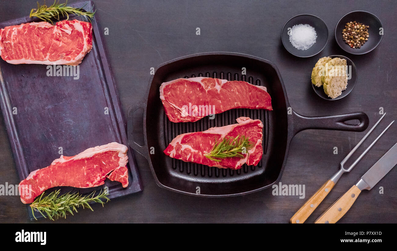 Raw New York strip steaks in cast iron frying pan Stock Photo Alamy