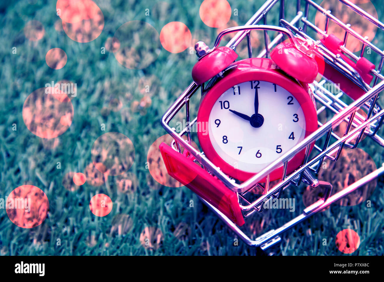 Red clock on the shopping cart, lack of time, waste of time, purchasing time, Shopping concept, Business concept. Stock Photo