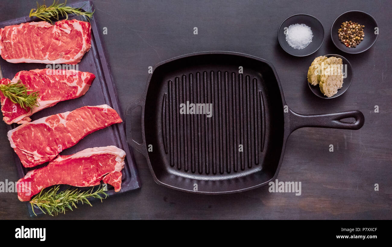Raw New York strip steaks in cast iron frying pan Stock Photo Alamy