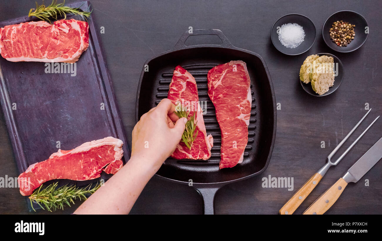 Raw New York strip steaks in cast iron frying pan Stock Photo Alamy