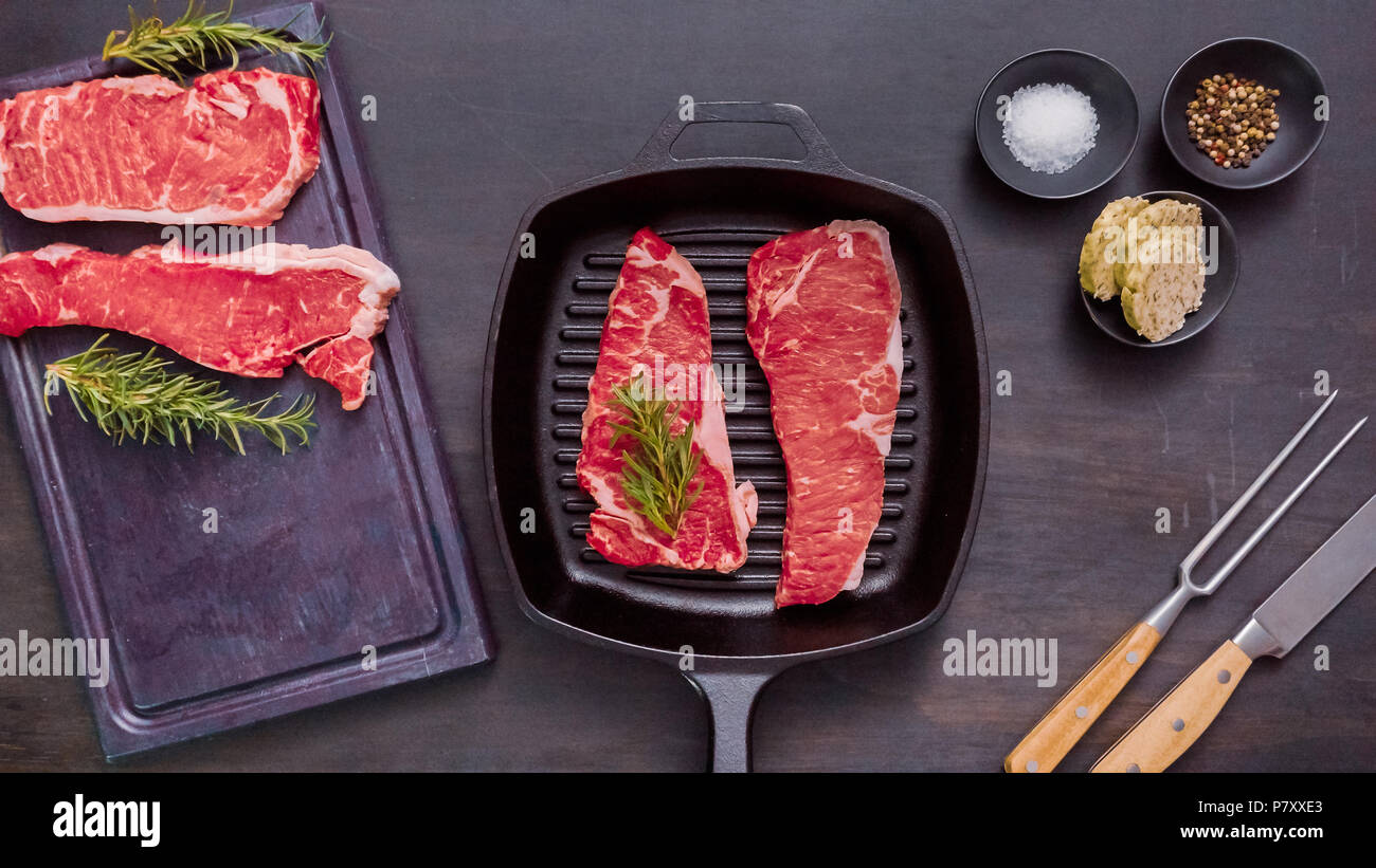 Raw New York strip steaks in cast iron frying pan Stock Photo - Alamy