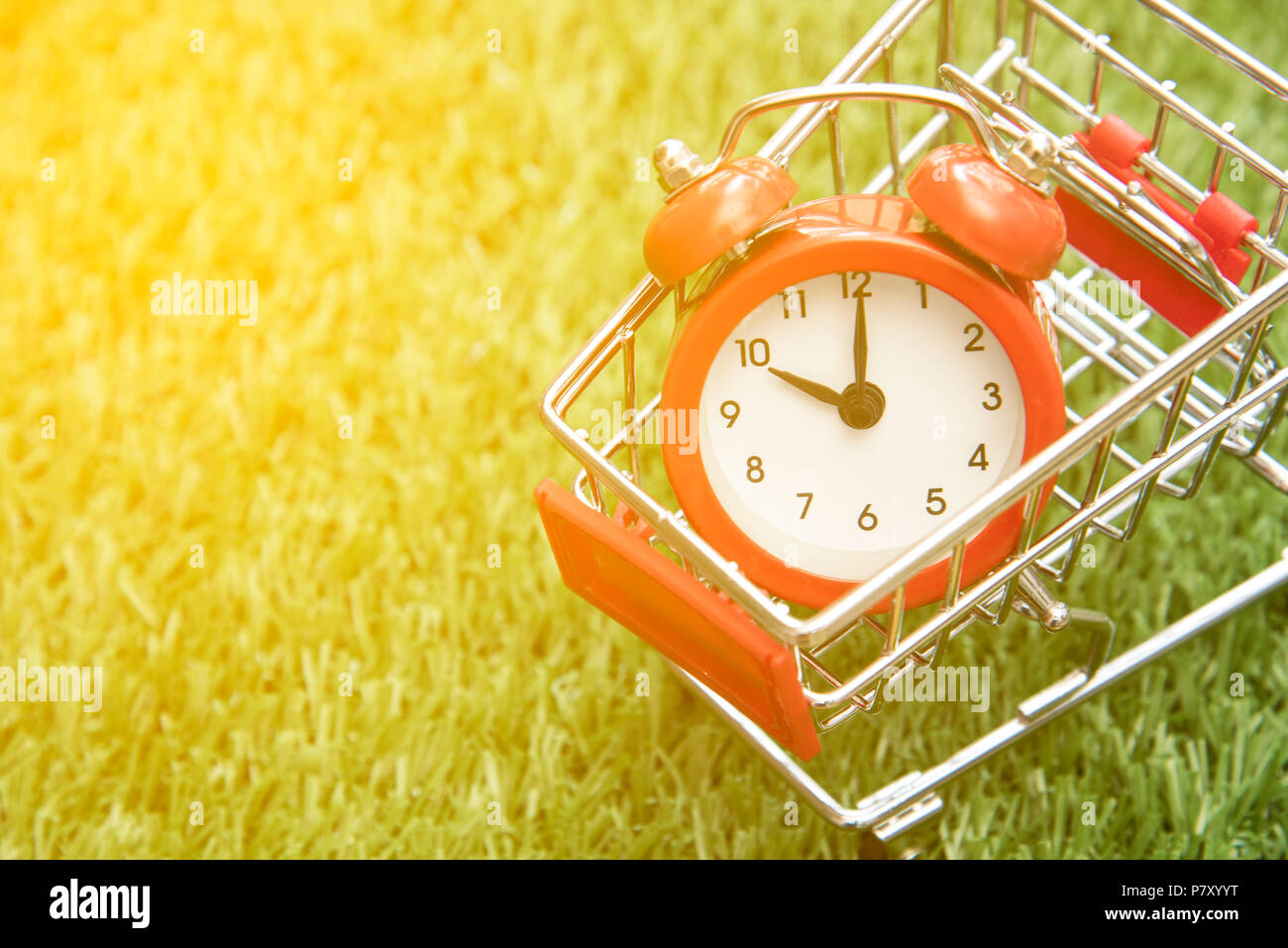Red clock on the shopping cart, lack of time, waste of time, purchasing time Stock Photo