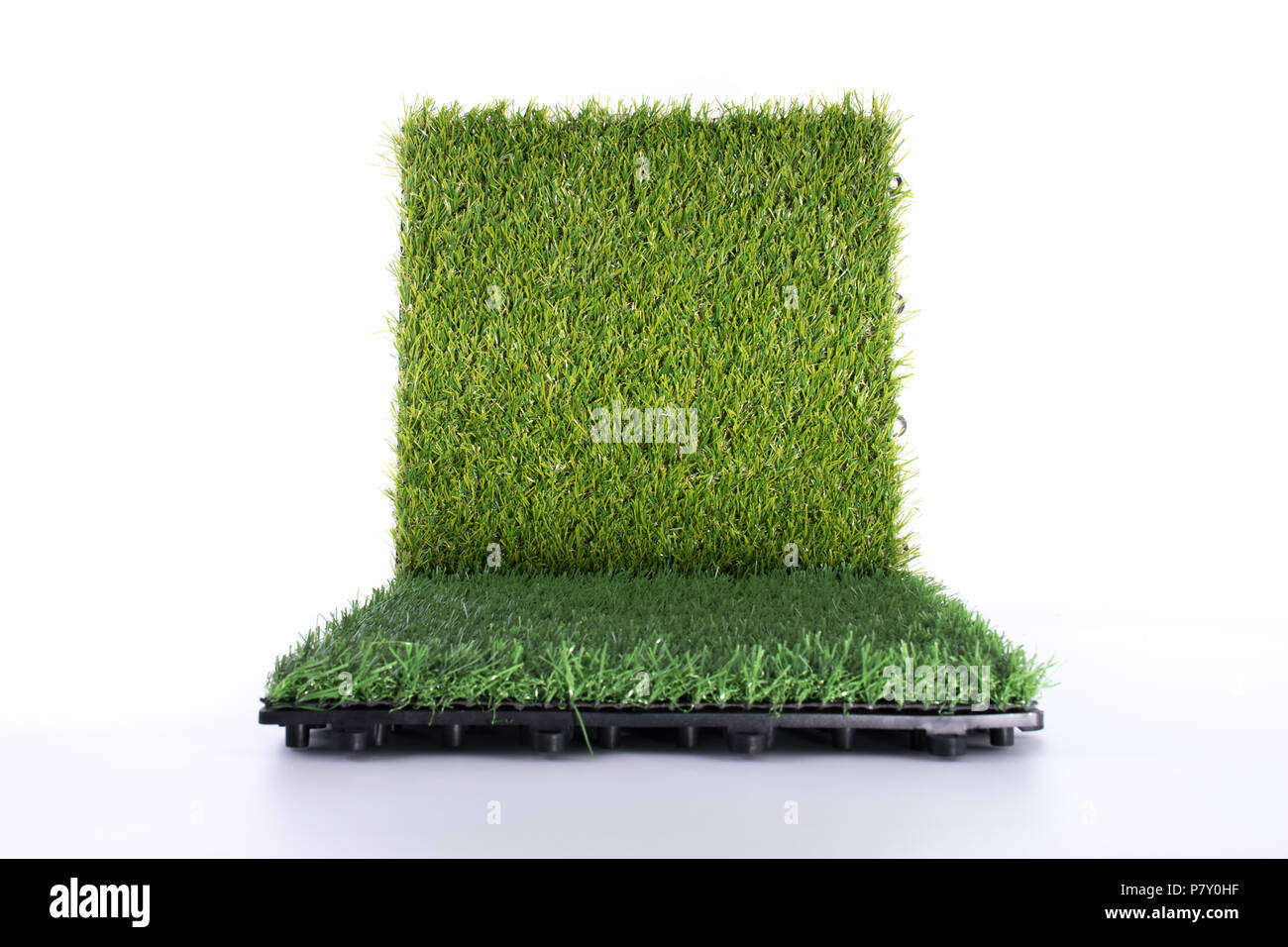 Grass mat on white background. Artificial turf tile background. Object and background concept. Stock Photo
