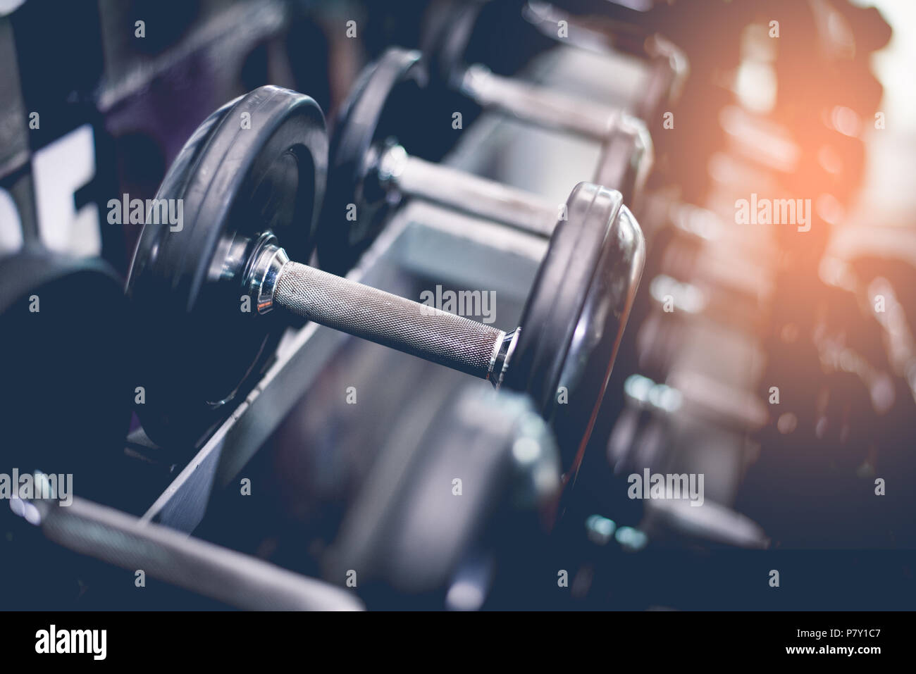 Black steel dumbbell set. Close up of dumbbells on rack in sport fitness  center. Workout training and fitness gym concept. Healthy and well being  conc Stock Photo - Alamy