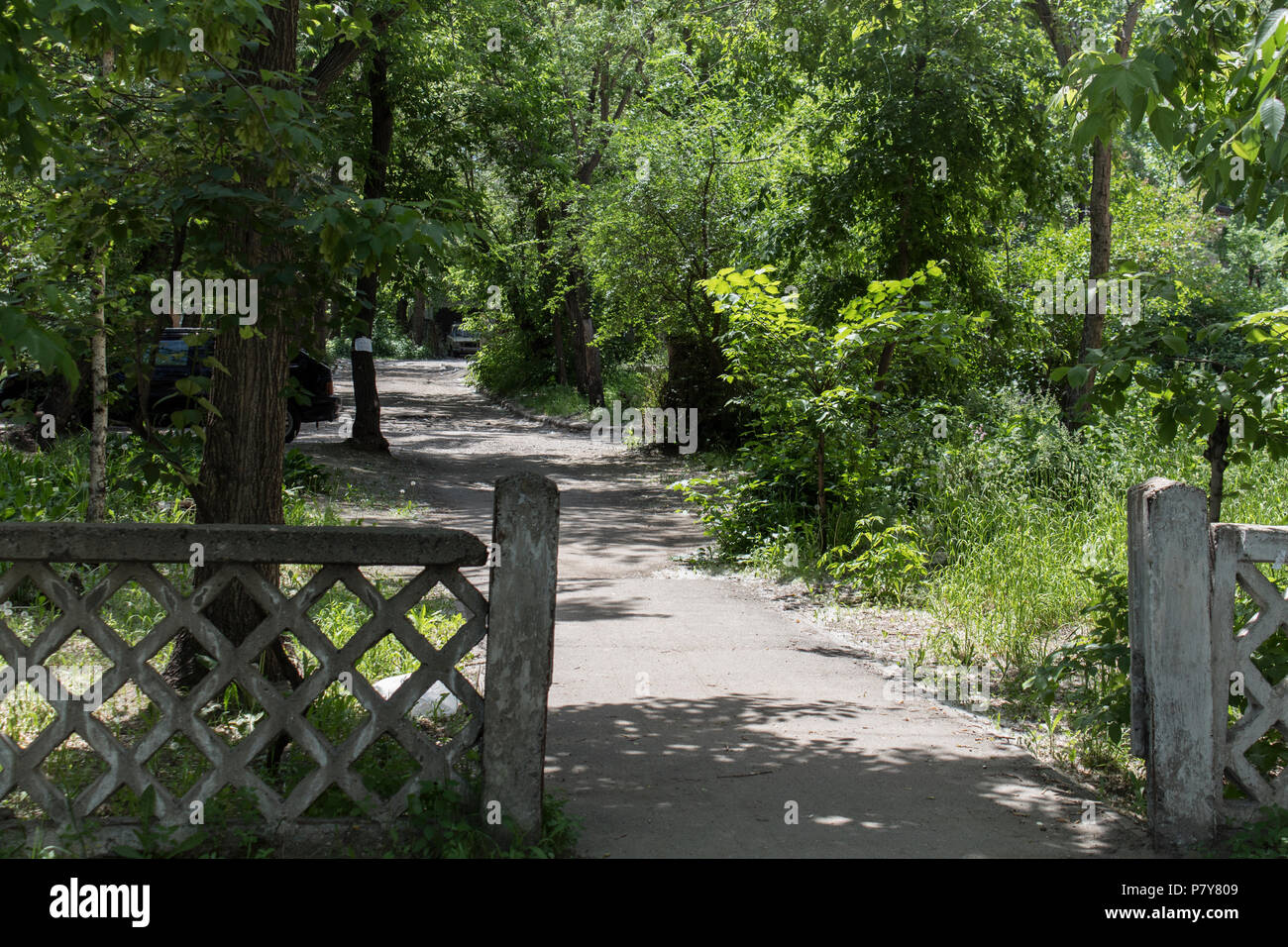 Old concrete fence and pedestrian path. Old architecture. Stock Photo