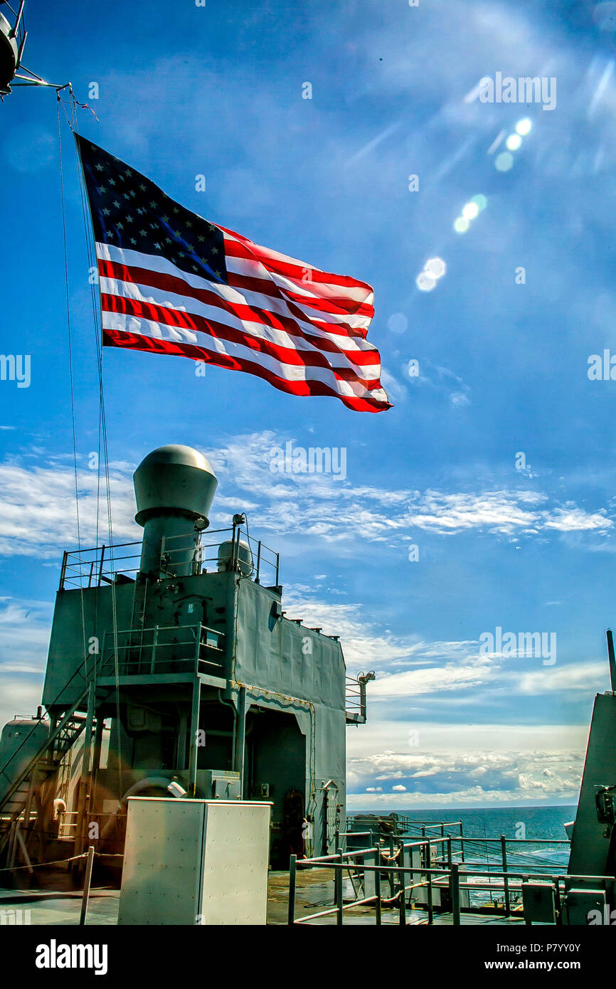 POLAND (June 24, 2018) The American Flag is flown aboard the Harpers Ferry-class dock landing ship USS Oak Hill (LSD 51) during the ship's participation in the celebration of the Polish Navy's 100th birthday, June 24, 2018. Oak Hill, home-ported in Virginia Beach, Virginia, and the 26th Marine Expeditionary Unit are conducting naval operations in the U.S. 6th Fleet area of operations. (U.S. Marine Corps photo by Staff Sgt. Dengrier M. Baez/Released) Stock Photo