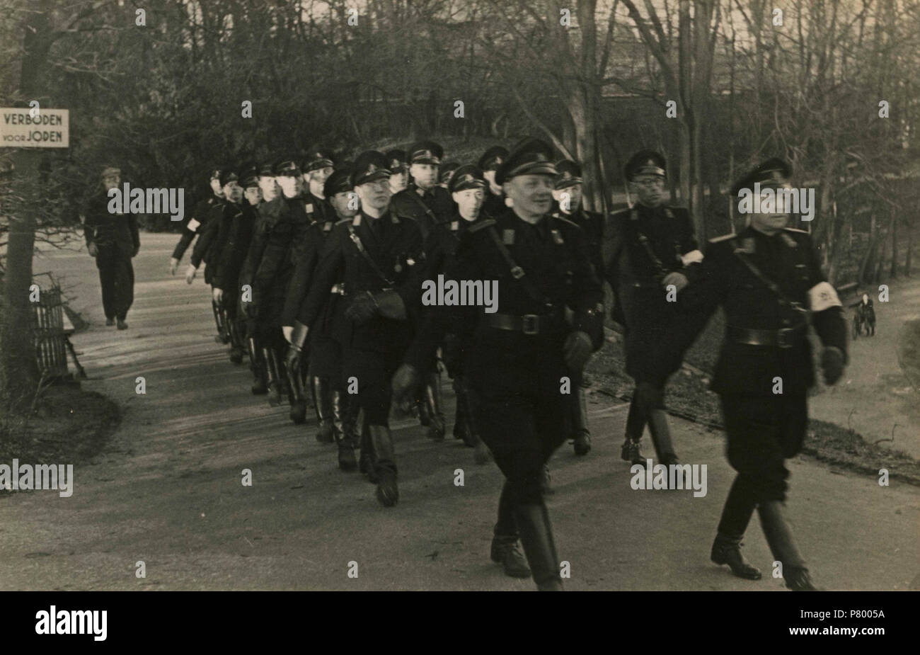 . Mars WA. Nederlands: De WA marcheert langs een bord 'Verboden voor joden'. Deze foto is afkomstig uit het archief van de Fotodienst der NSB. Unknown date 261 Mars WA - Fotodienst der NSB - NIOD - 210669 Stock Photo