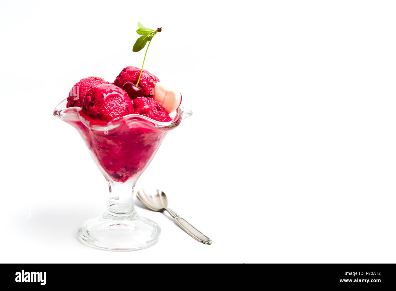 Cherry ice cream scoops in a cup on white Stock Photo