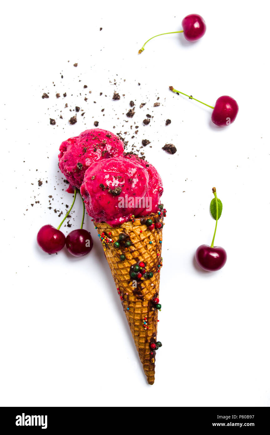 Cherry ice cream scoops in a cone on white Stock Photo