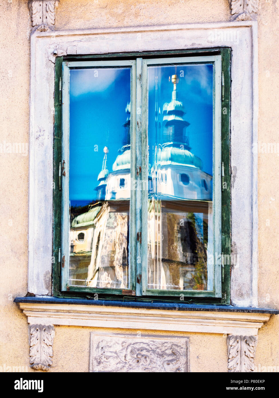 The belltowers of Ljubljana Cathedral reflected in an window of an ancient building, Ljubljana, Slovenia Stock Photo