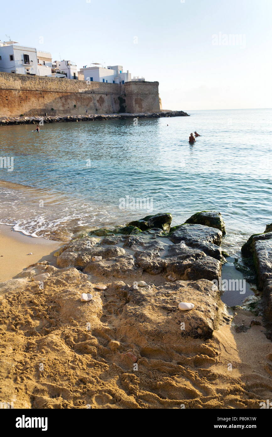 Sunrise on beach Porta Vecchia near Cathedral in Monopoli, Italy Stock Photo