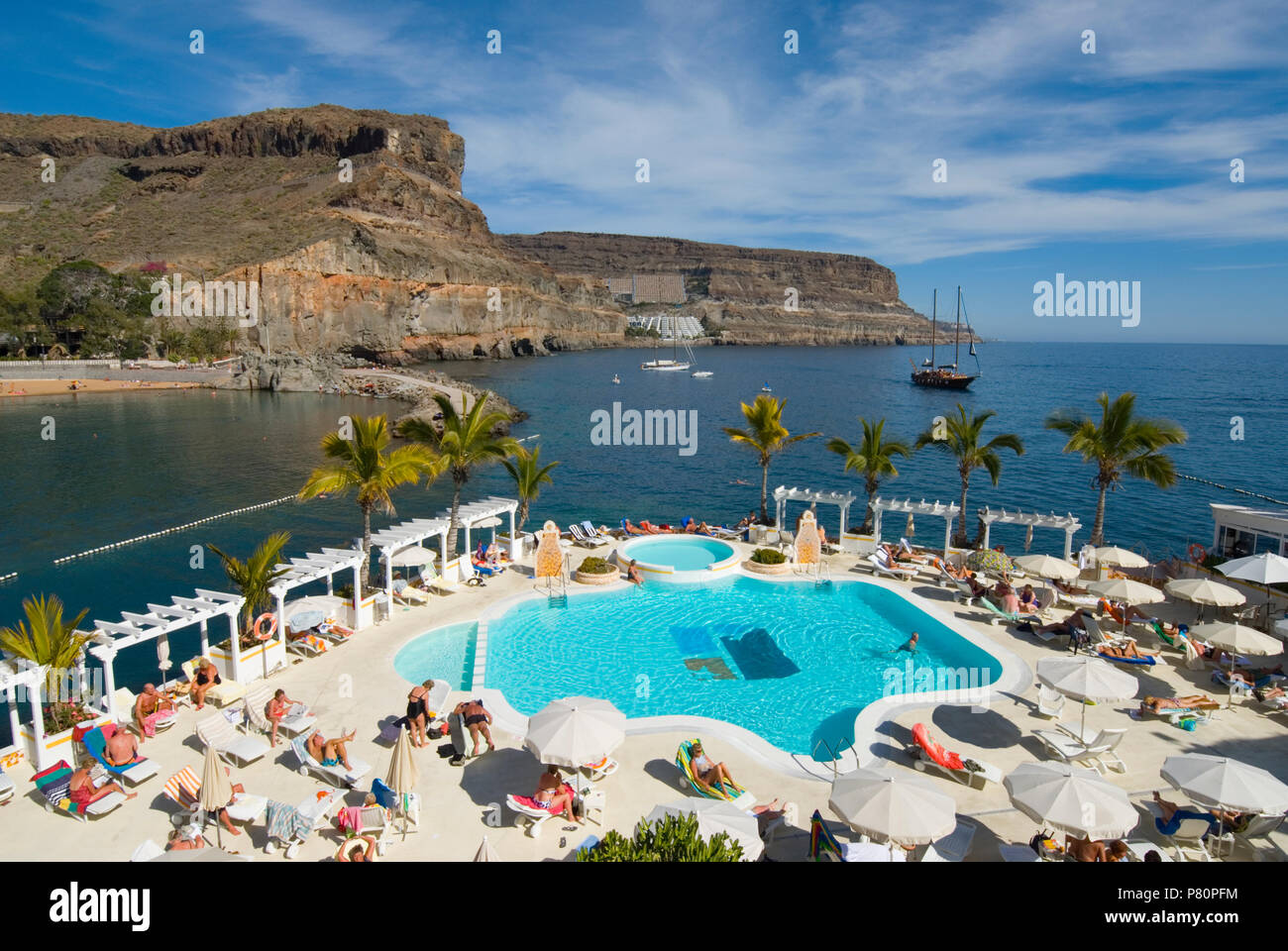 Hotel swimming pool and rugged coastline of Puerto de Mogan Stock Photo