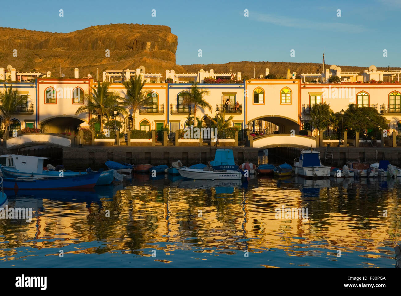 View of whitewashed holiday apartments on waterfront at Puerto de Mogan Stock Photo