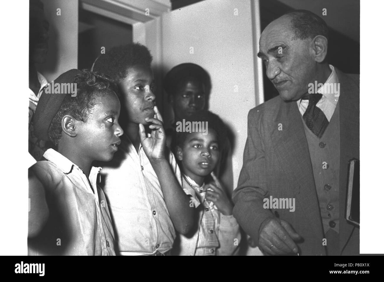 :   ,     ,   '  '  1955 English: Original description: ABYSSINNIAN JEWISH CHILDREN, NOW ON TWO YEAR TRAINING COURSE AT KFAR BATYA, VISIT PROFESSOR FEITELOWITZ WHO DISCOVERED THEIR COMMUNITY WHILST IN ABYSSINNIA. 1 May 1955 101 D459-119 Stock Photo