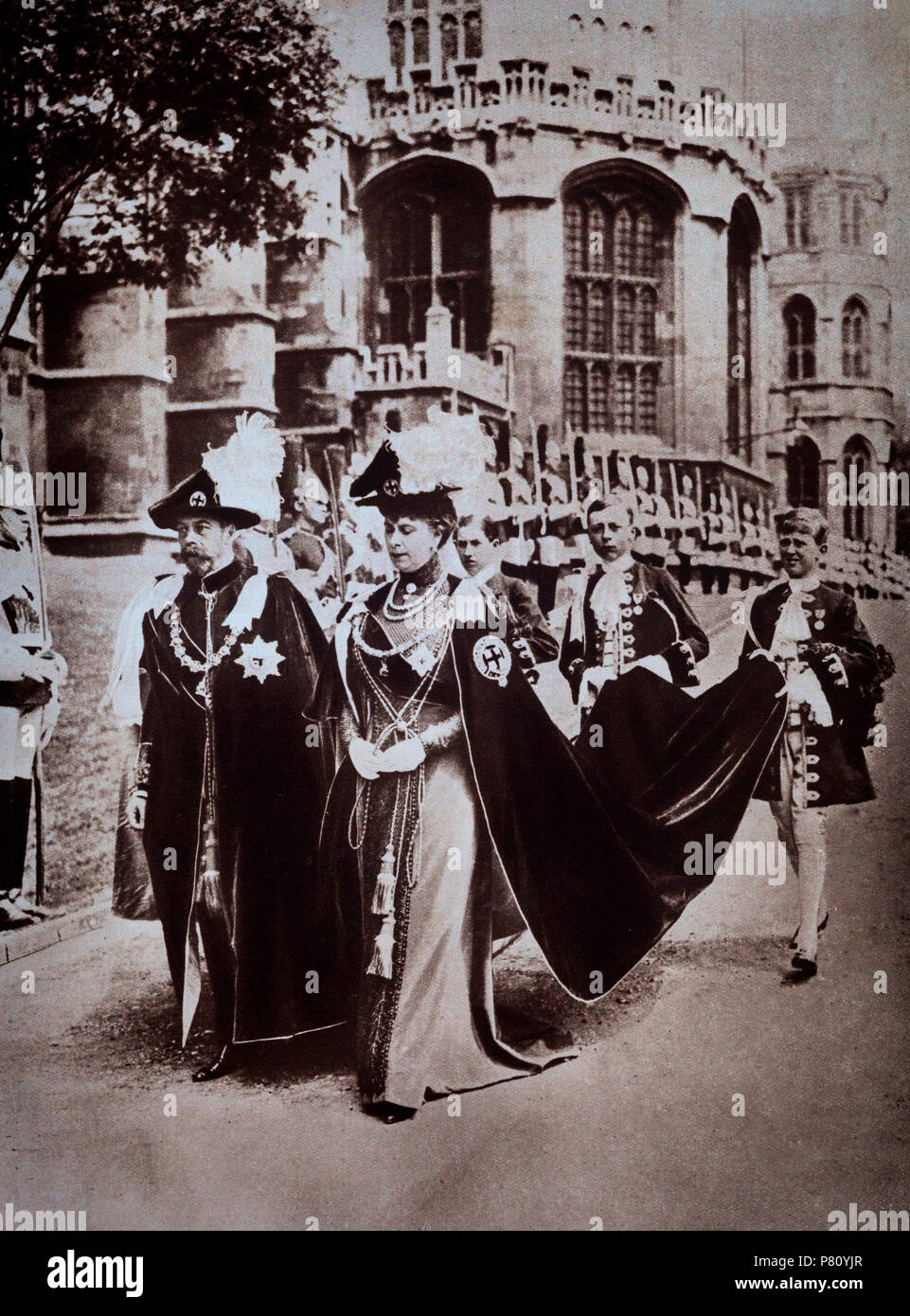 King George V and Queen Mary in the robes and insignia of the Order of the Garter (formally the Most Noble Order of the Garter), an order of chivalry founded by Edward III in 1348 and regarded as the most prestigious British order of chivalry (though in precedence inferior to the military Victoria Cross and George Cross) in England and the United Kingdom. It is dedicated to the image and arms of Saint George, England's patron saint. Stock Photo