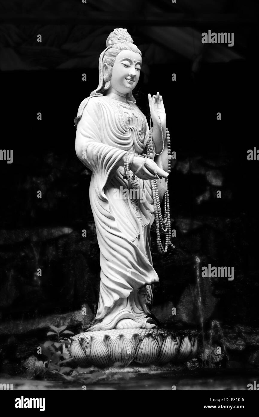 Statue of Bodhisattva Kuan on a lotus. Statues in public places at the