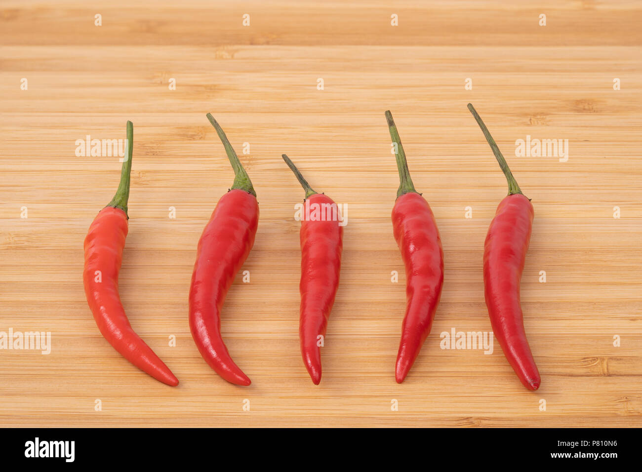 Close up red hot chilli pepper on wood chopping board Stock Photo - Alamy