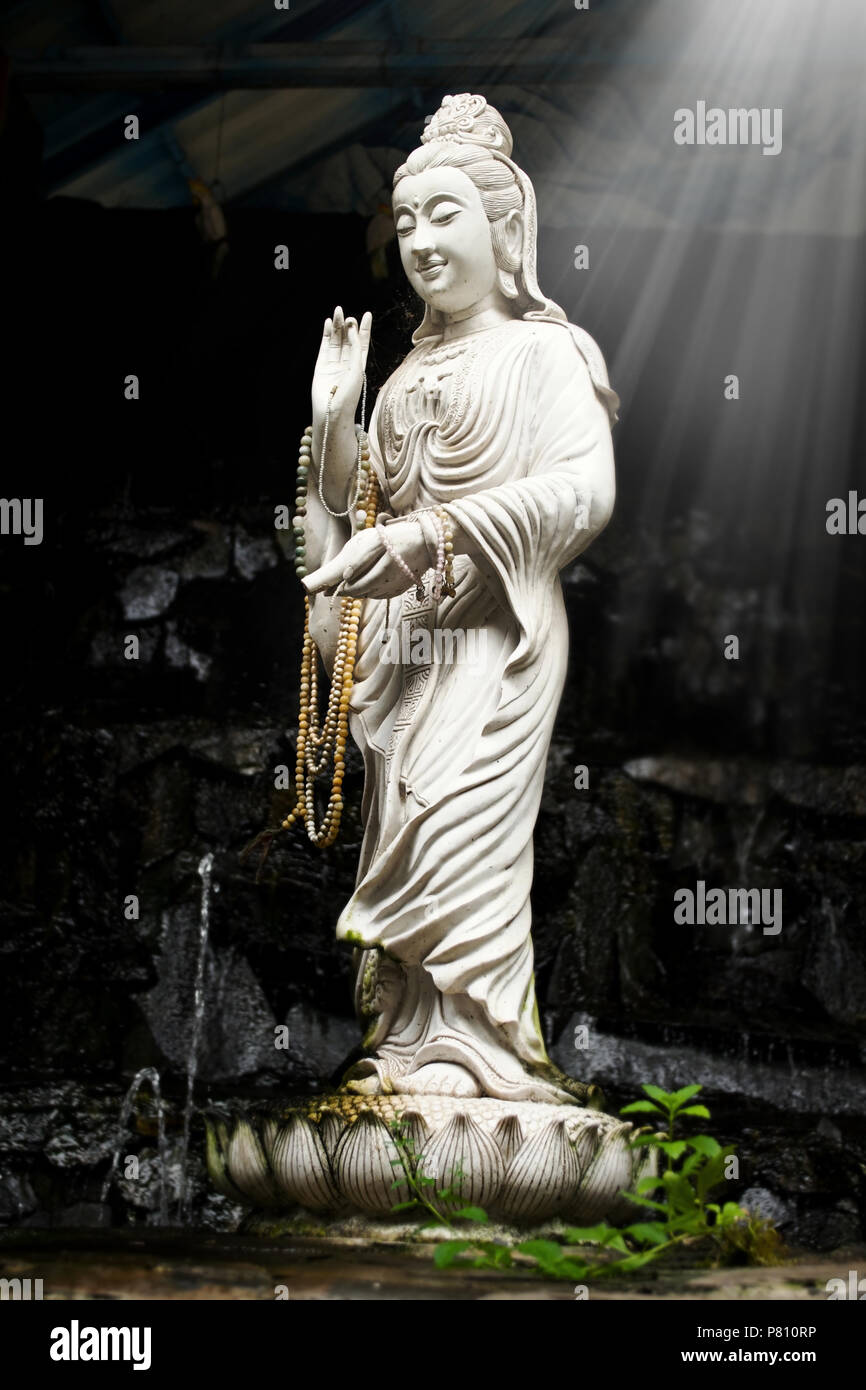 Statue of Bodhisattva Kuan on a lotus. Statues in public places at the